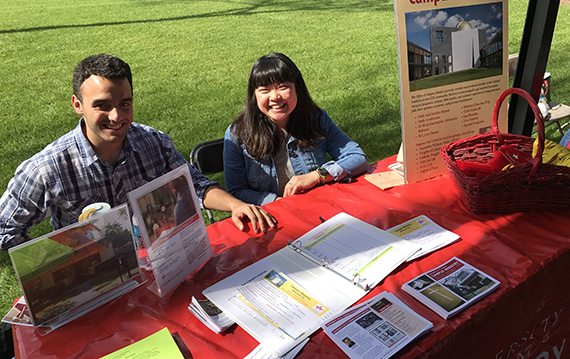 University of St. Thomas – Houston Campus Ministry students share info at their table