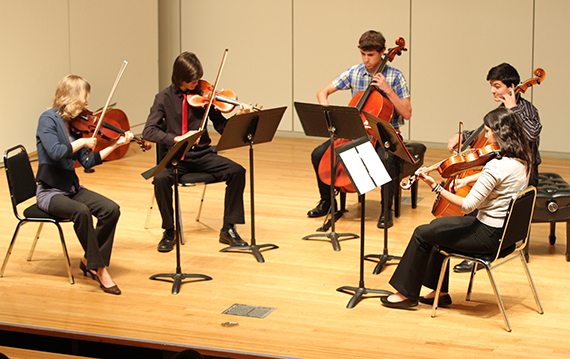 Musicians play on stage in Cullen Recital Hall at the University of St. Thomas - Houston