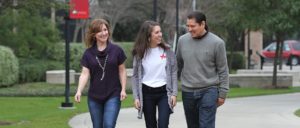 A UST student and her parents walk through the University of St. Thomas - Houston campus