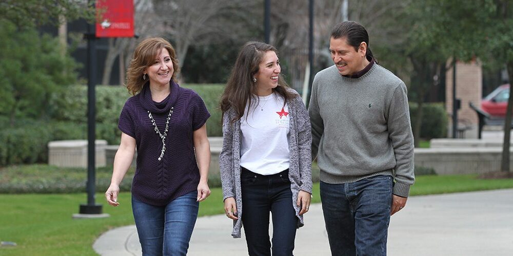 A UST student and her parents walk through the University of St. Thomas - Houston campus