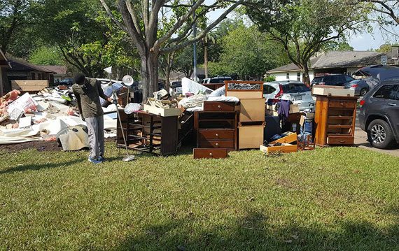 Furniture and debris outside University of St. Thomas - Houston student Vawn Stearnes' home after Hurricane Harvey flooding