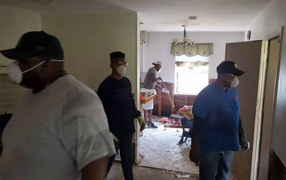 Cleanup inside the home of University of St. Thomas - Houston student Vawn Stearnes' home after Hurricane Harvey flooding