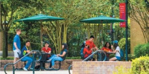 Students sitting at picnic tables on the UST campus